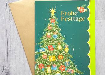 Kartka grająca bożonarodzeniowe z muzyką z kopertą Wesołych Świąt.