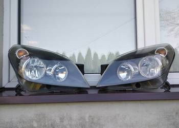 Opel Astra H lampy przednie reflektory prawy lewy komplet Hella oryginał OE